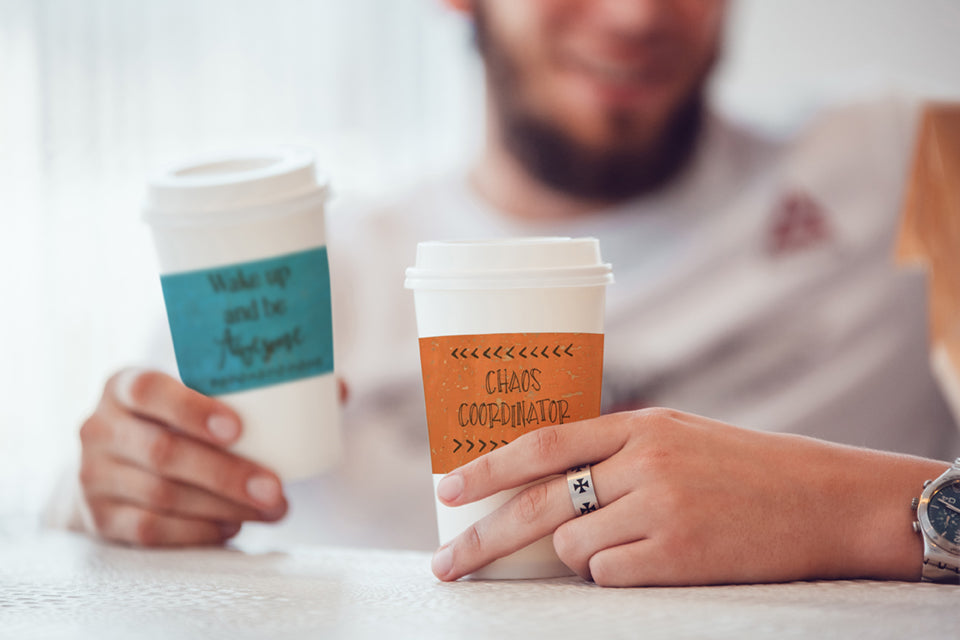 Friends having coffee and cups have cork fabric cup sleeves
