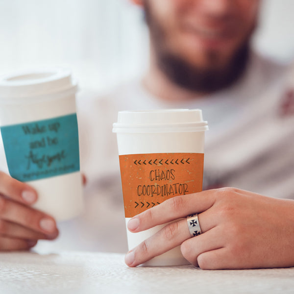 Friends having coffee and cups have cork fabric cup sleeves