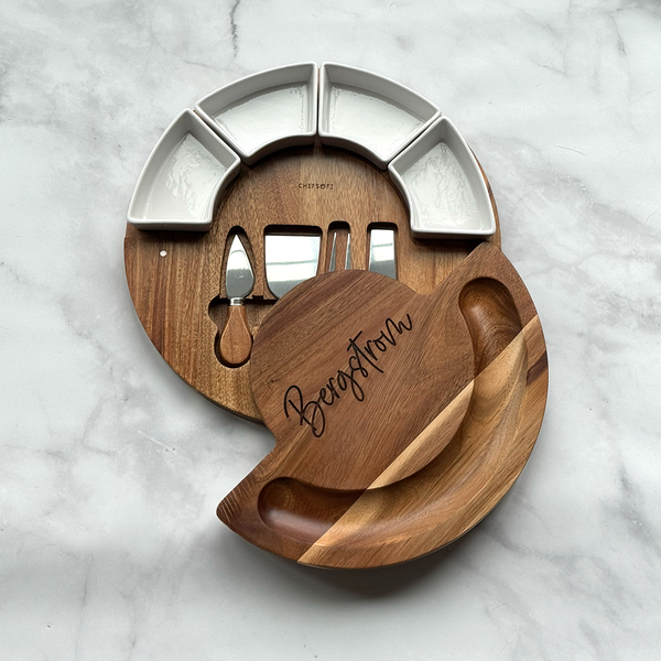 Wooden and metal cheese board set on a marble surface
