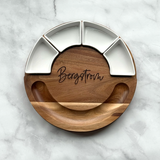 Wooden and metal divided plate with 'Bergstrom' engraving on a marble background