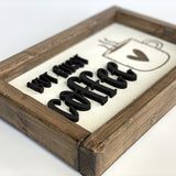closeup of but first coffee wood sign