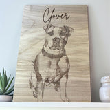 Wooden plaque with a engraved portrait of a dog named 'Clover' on a light background.