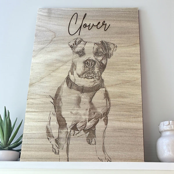 Wooden plaque with a engraved portrait of a dog named 'Clover' on a light background.