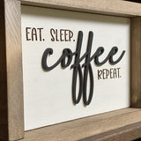 Closeup of Eat Sleep coffee repeat wood sign