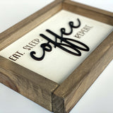 Side view of eat sleep coffee repeat wood sign