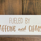 Closeup of fueled by Caffeine and Chaos wood sign
