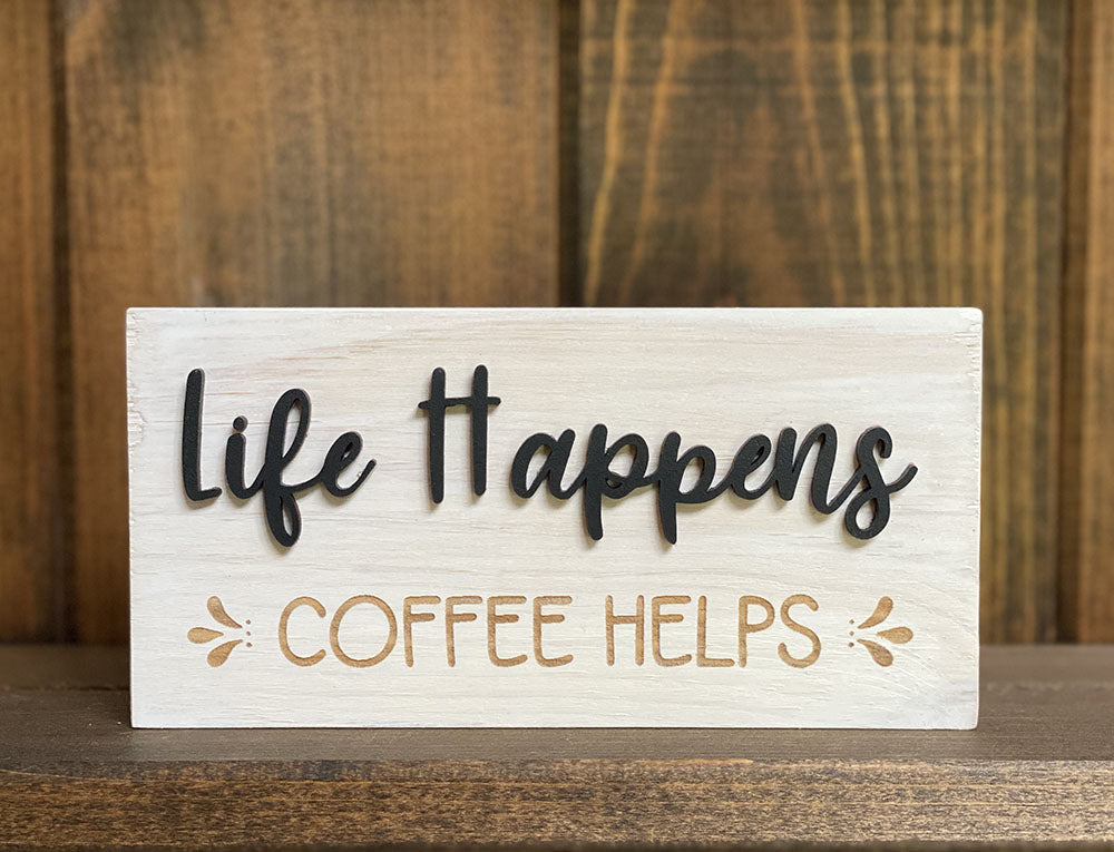 Close up of life happens coffee helps wood sign
