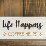 Close up of life happens coffee helps wood sign