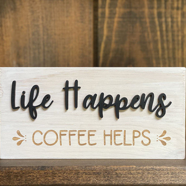 Close up of life happens coffee helps wood sign