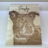 Wooden plaque with engraved dog portrait and name 'Paisley' on a white background