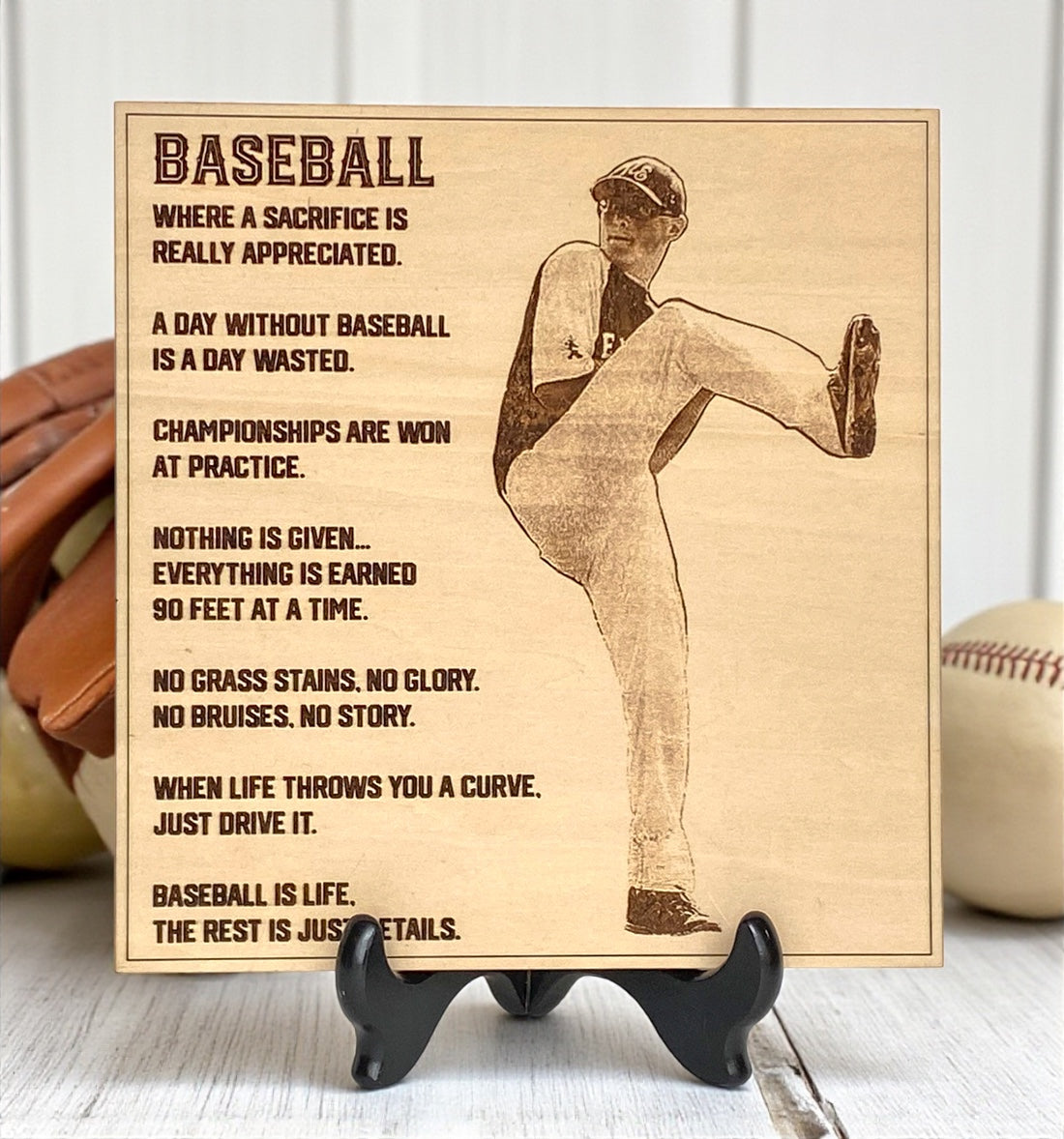 Wooden plaque engraved with a baseball player photo and text on a stand.