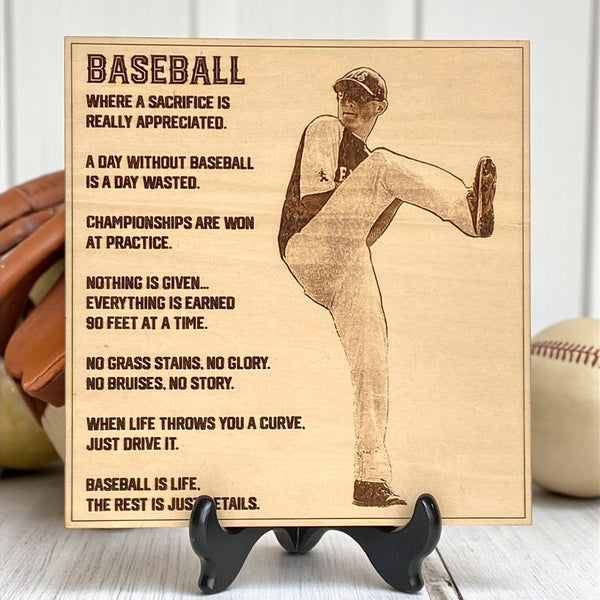 Wooden plaque engraved with a baseball player photo and text on a stand.