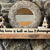 Mantle with mirror and wood sign