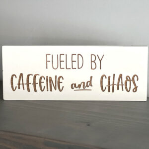Fueled by caffeine and chaos wood sign on gray shelf