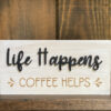 Close up of life happens coffee helps wood sign