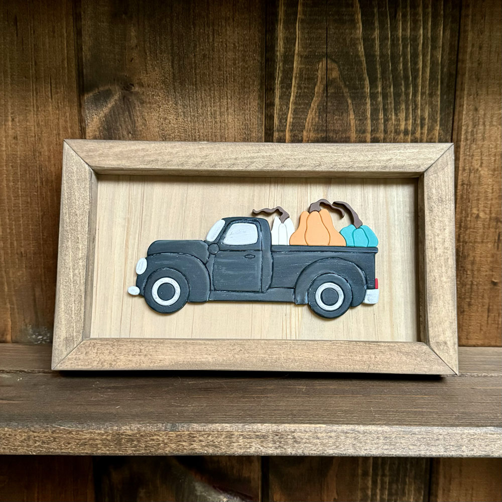 Pickup truck with pumpkins framed sign