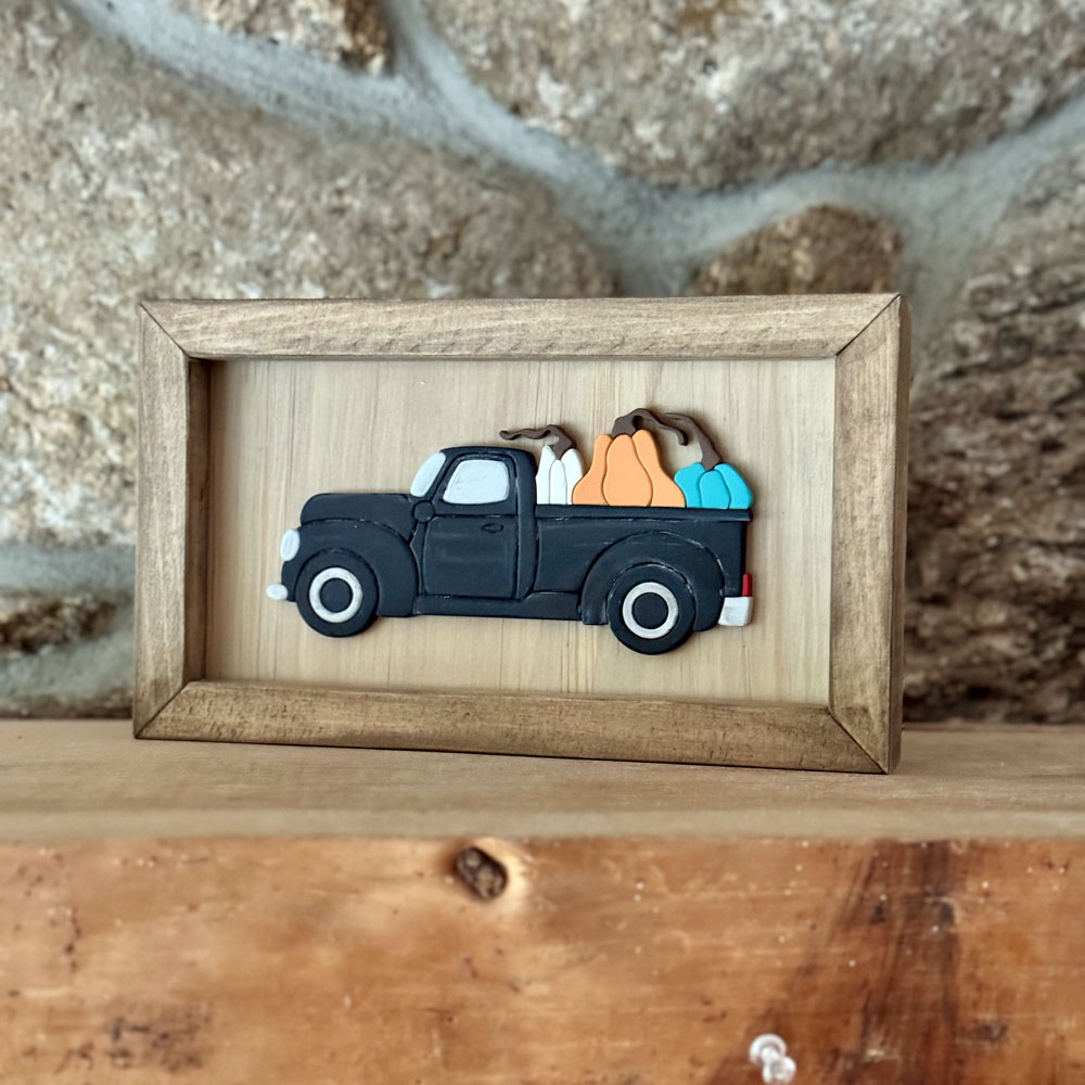 Pickup truck with pumpkins framed sign